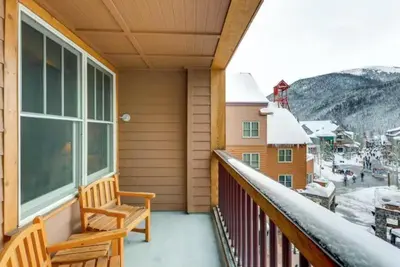 a balcony with a bench and a view of a town at Buffalo Lodge 1 Bedroom In River Run in Keystone