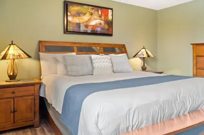 a bedroom with a large bed and two lamps at Cozy 2BR with Great Views Near Trails in Silverthorne