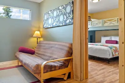 a bedroom with a bunk bed and a chair at Cozy 2BR with Great Views Near Trails in Silverthorne