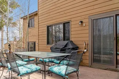 a table and chairs on a patio with a grill at Cozy 2BR with Great Views Near Trails in Silverthorne