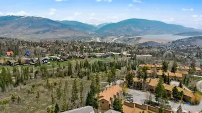 an aerial view of a resort with mountains and a lake at Cozy 2BR with Great Views Near Trails in Silverthorne