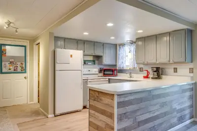 a kitchen with white appliances and a white refrigerator at 8 Mi to Dtwn Denver Wheat Ridge Gem with Patio in Wheat Ridge
