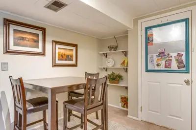 a dining room with a wooden table and chairs at 8 Mi to Dtwn Denver Wheat Ridge Gem with Patio in Wheat Ridge