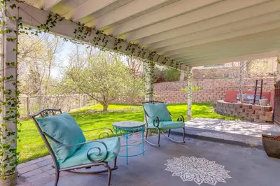 a pergola with two chairs and a table on a patio at 8 Mi to Dtwn Denver Wheat Ridge Gem with Patio in Wheat Ridge