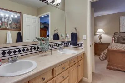 a bathroom with two sinks and a large mirror at 1 Mi to Cherry Creek State Park Home with Game Room in Centennial