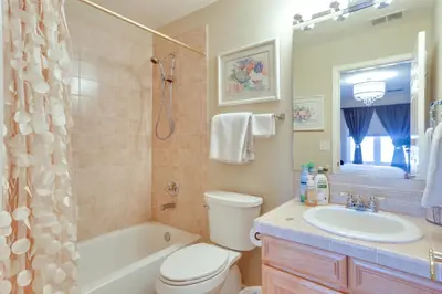 a bathroom with a tub and a toilet and a sink at 1 Mi to Cherry Creek State Park Home with Game Room in Centennial