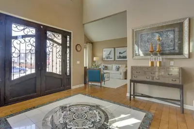 a living room with a door and a table at 1 Mi to Cherry Creek State Park Home with Game Room in Centennial