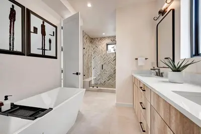a bathroom with a large white tub and two sinks at Luxury Townhouse in the Heart of LoHi in Denver