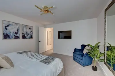 a bedroom with a bed and a ceiling fan at Luxury Townhouse in the Heart of LoHi in Denver
