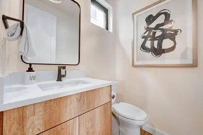 a bathroom with a sink and a toilet and a mirror at Luxury Townhouse in the Heart of LoHi in Denver