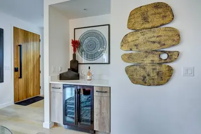 a living room with a stone wall and a fireplace at Luxury Townhouse in the Heart of LoHi in Denver