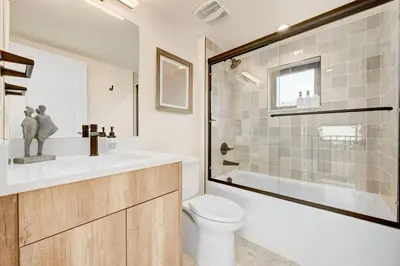 a bathroom with a toilet and a sink and a shower at Luxury Townhouse in the Heart of LoHi in Denver