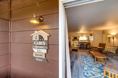 a barn house with a living room and a dining room at Riverfront Condo Near Downtown Estes Park! in Estes Park