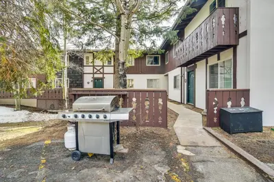a barbecue grill in front of a building at Riverfront Condo Near Downtown Estes Park! in Estes Park