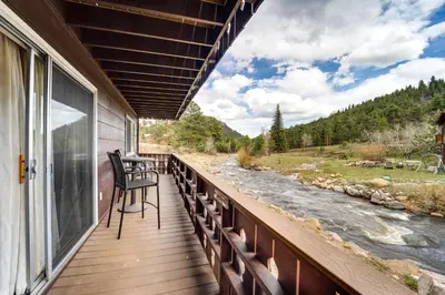 a balcony with a view of a river at Riverfront Condo Near Downtown Estes Park! in Estes Park