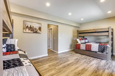 two bunk beds in a room with wooden floors at 8 Mi to Keystone Home with Hot Tub in Dillon in Dillon