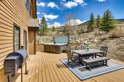 a deck with a barbecue and a table and chairs at 8 Mi to Keystone Home with Hot Tub in Dillon in Dillon