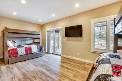 a bedroom with two beds and a flat screen tv at 8 Mi to Keystone Home with Hot Tub in Dillon in Dillon