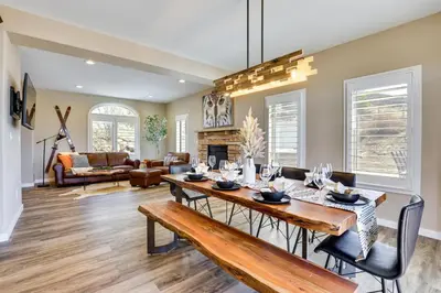 a dining room with a table and chairs and a living room at 8 Mi to Keystone Home with Hot Tub in Dillon in Dillon