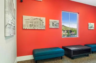 a room with a red wall with two stools and a window at 1 Mi to Dtwn Cozy Retreat in Golden, CO! in Golden
