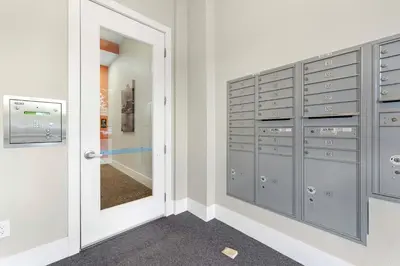 a locker room with gray lockers and a mirror at 1 Mi to Dtwn Cozy Retreat in Golden, CO! in Golden