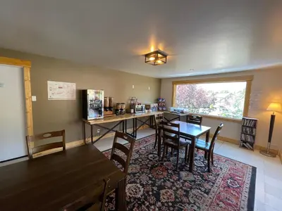 a room with a table and chairs and a kitchen at Estes Mountain Inn in Estes Park