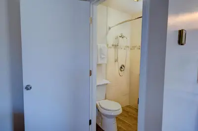 a bathroom with a toilet and a shower at Estes Mountain Inn in Estes Park