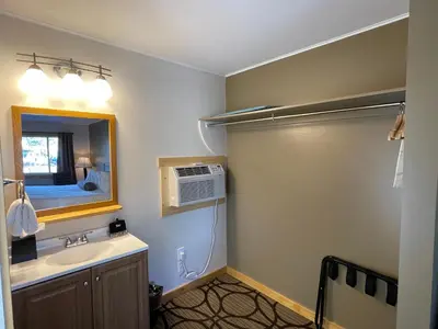 a bathroom with a sink and a air conditioner at Estes Mountain Inn in Estes Park
