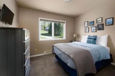 a bedroom with a bed and a window at Lake Dillon Retreat Townhome: Panoramic Lake, Mountain Views in Dillon