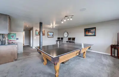 a living room with a ping pong table in it at Lake Dillon Retreat Townhome: Panoramic Lake, Mountain Views in Dillon