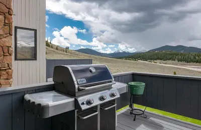 a grill on a deck with a view of a mountain at Lake Dillon Retreat Townhome: Panoramic Lake, Mountain Views in Dillon