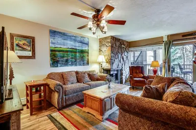a living room with two couches and a ceiling fan at 1 Mi to Marina Frisco Condo with Mtn-View Balcony! in Frisco