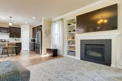 a living room with a fireplace and a kitchen at Westminster Home with Patio and BBQ Near Dtwn Denver in Westminster