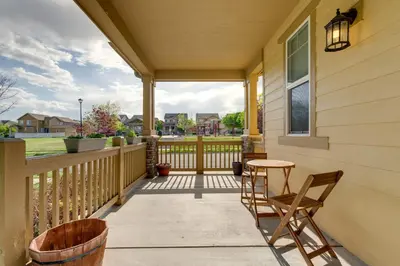 a porch with a table and chairs on a house at Westminster Home with Patio and BBQ Near Dtwn Denver in Westminster