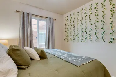 a bedroom with a large bed with a window at Westminster Home with Patio and BBQ Near Dtwn Denver in Westminster