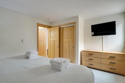 a bedroom with a bed with a tv and a dresser at Ski Retreat Keystone Resort Condo with Heated Pool! in Keystone