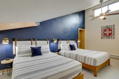two beds in a room with blue walls at Ski Retreat Keystone Resort Condo with Heated Pool! in Keystone