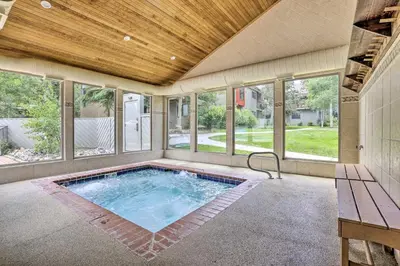 an indoor swimming pool in a house with windows at Ski Retreat Keystone Resort Condo with Heated Pool! in Keystone