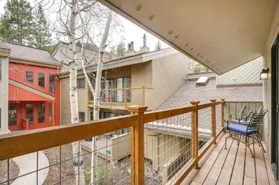 a balcony with a blue chair on a wooden deck at Ski Retreat Keystone Resort Condo with Heated Pool! in Keystone