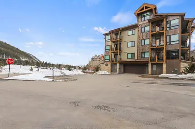 a parking lot in front of a building with a stop sign at The Snake River Chalet in Keystone