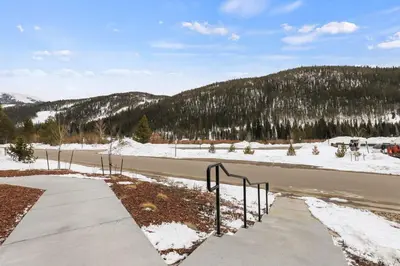 a road with snow and trees on the side of it at The Snake River Chalet in Keystone