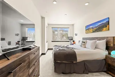 a bedroom with a large bed and a television at The Snake River Chalet in Keystone