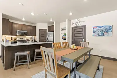 a kitchen and dining room with a table and chairs at The Snake River Chalet in Keystone