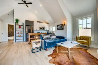 a living room with a blue couch and a table at 14 Mi to Dtwn Denver Sleek Westminster Home in Westminster