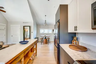 a kitchen with white cabinets and a wooden counter top at 14 Mi to Dtwn Denver Sleek Westminster Home in Westminster