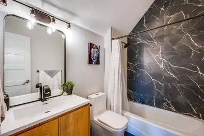 a bathroom with a sink and a toilet and a tub at 14 Mi to Dtwn Denver Sleek Westminster Home in Westminster