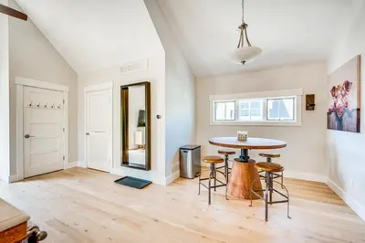 a living room with a table and stools at 14 Mi to Dtwn Denver Sleek Westminster Home in Westminster