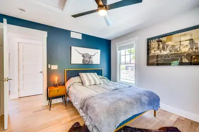 a bedroom with a bed with a blue wall at 14 Mi to Dtwn Denver Sleek Westminster Home in Westminster