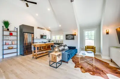 a living room with a blue couch and a kitchen at 14 Mi to Dtwn Denver Sleek Westminster Home in Westminster