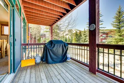 a porch of a house with a blue cover on it at Walk to Gondola Condo with Deck in Winter Park! in Winter Park